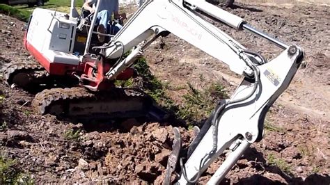 using a mini digger on a slope|how to use excavators on slopes.